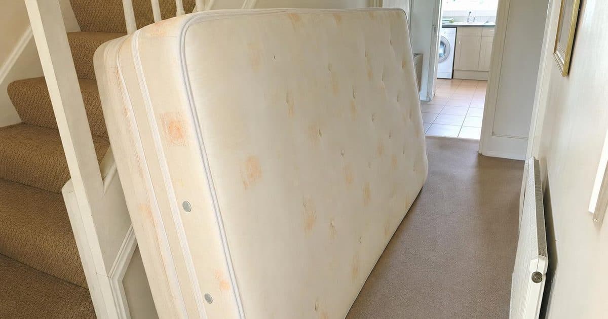 An old mattress propped against a wall ready for collection in Eastbourne